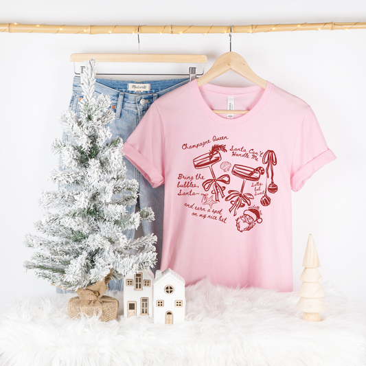 Champagne Queen Seashell Pink Tee – Coastal Santa Graphic Tee for Winter Comfort